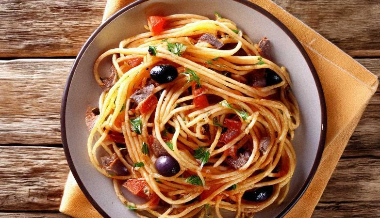 A plate of Spaghetti Puttanesca with olives, capers, and a rustic setting